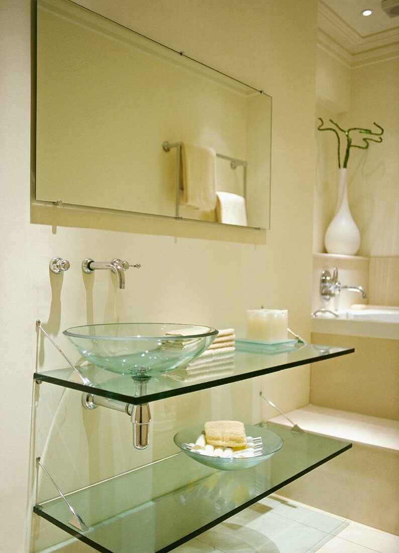 Modern, cream bathroom in classic setting with glass washstand and basin