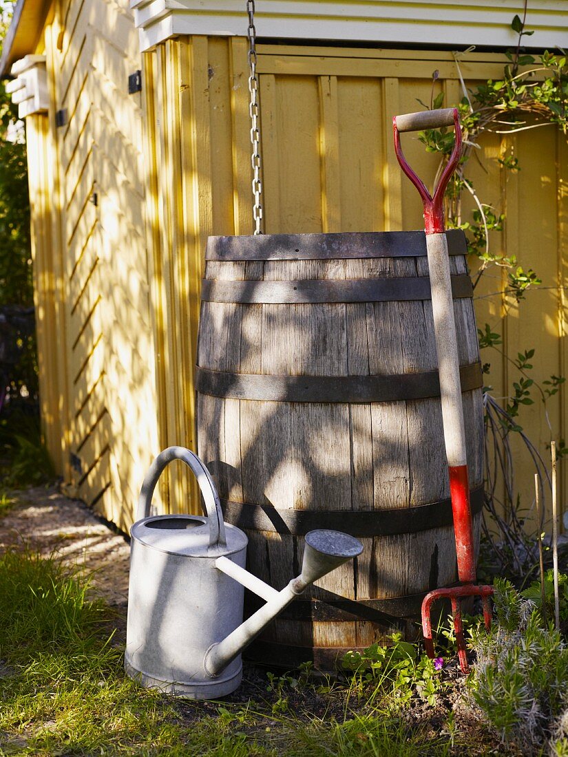 Tool shed with rain barrel, watering can and pitchfork