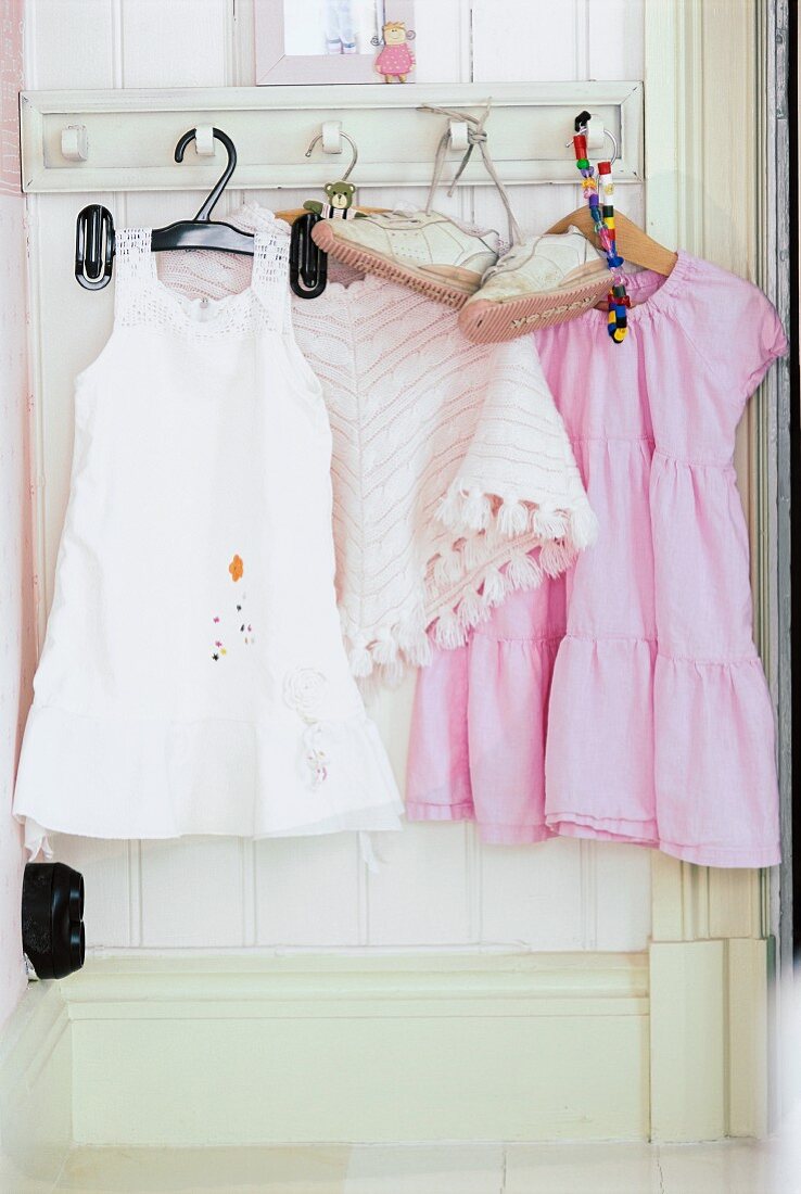 Children's clothes hanging in a closet