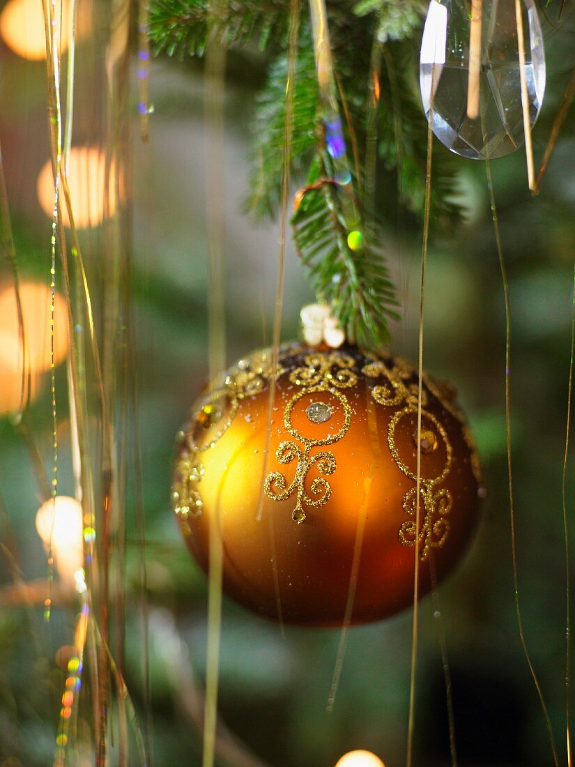 Decorated, gold Christmas ball and tinsel