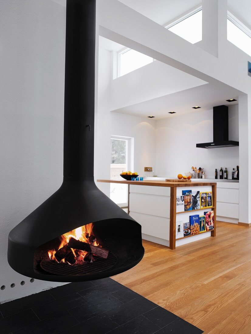 Open wood burning stove in a modern living room with a cooking area