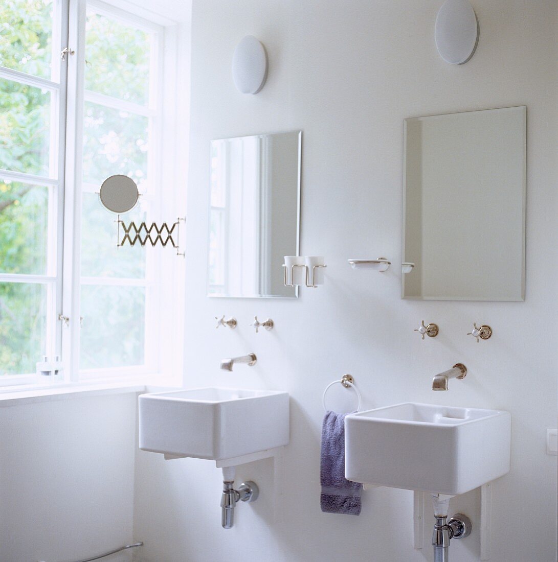 Bathroom with two sinks and wall fittings in retrostyle