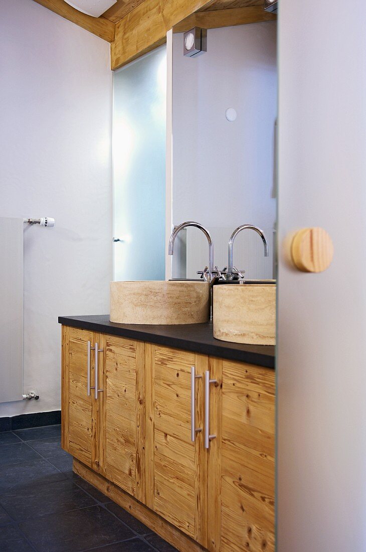 Modern bathroom with stone basins on wooden washstands