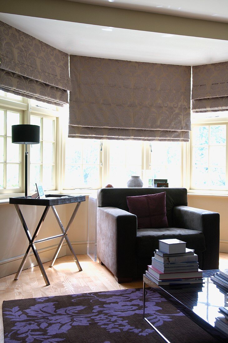 Elegant grey furnishings - armchair and half-closed blind in bay window
