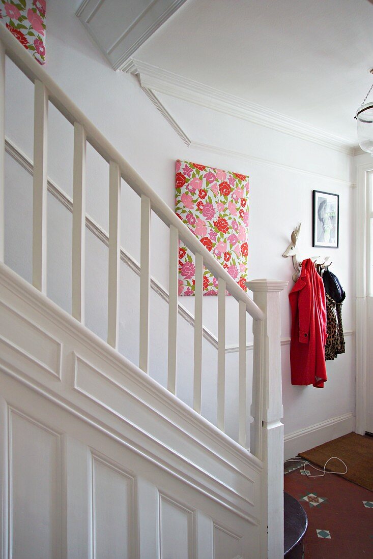 Rustic stairwell with white-painted balustrade
