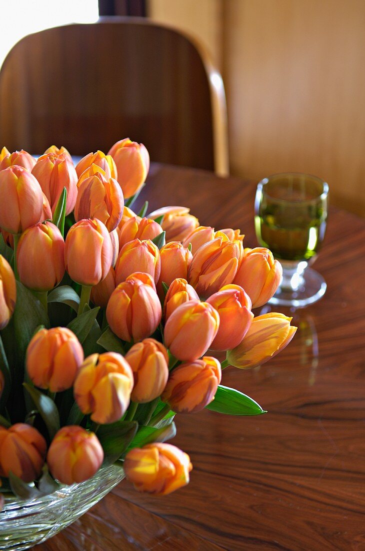 Bouquet of orange tulips on table