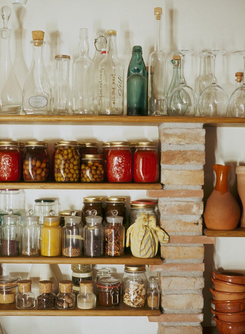 Storage jars and collection of bottles on shelving