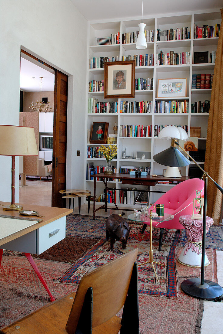 Library with tall bookcases and fifties-style desk
