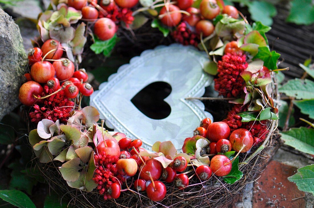 Vine wreath with rosehips and a metal heart