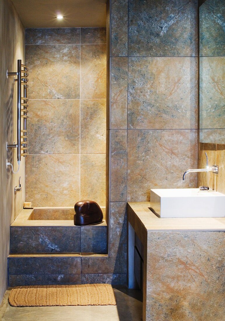 Large tiles in a modern bathroom with a built-in bathtub
