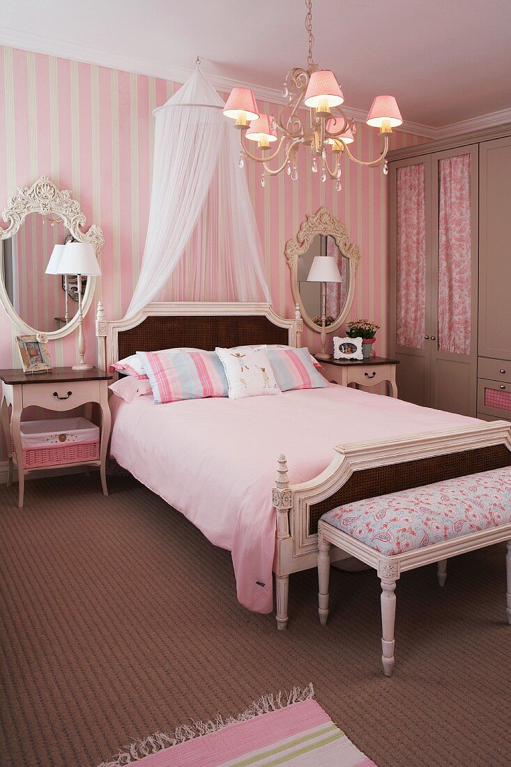 Baroque bedroom in pink with a canopy over the double bed