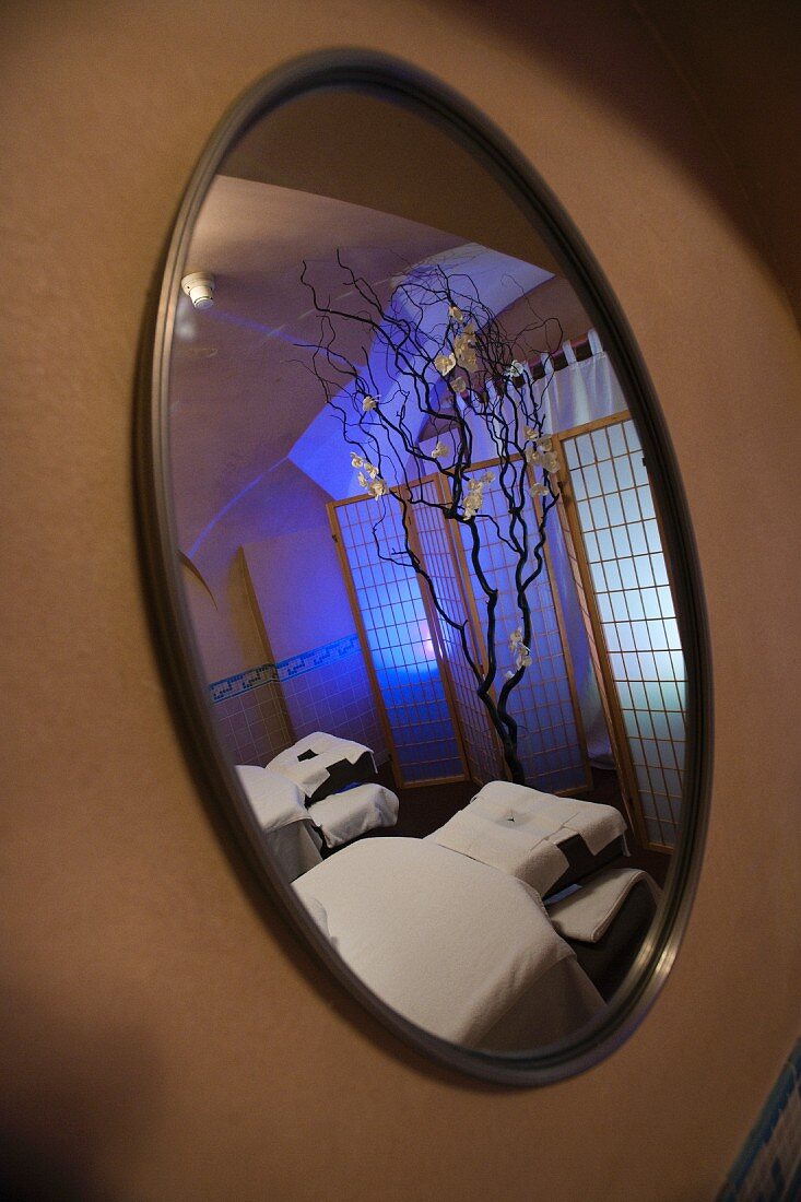 Spa room reflected in mirror on wall