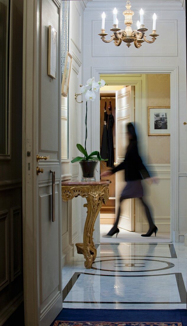 Woman walking through hallway in hotel