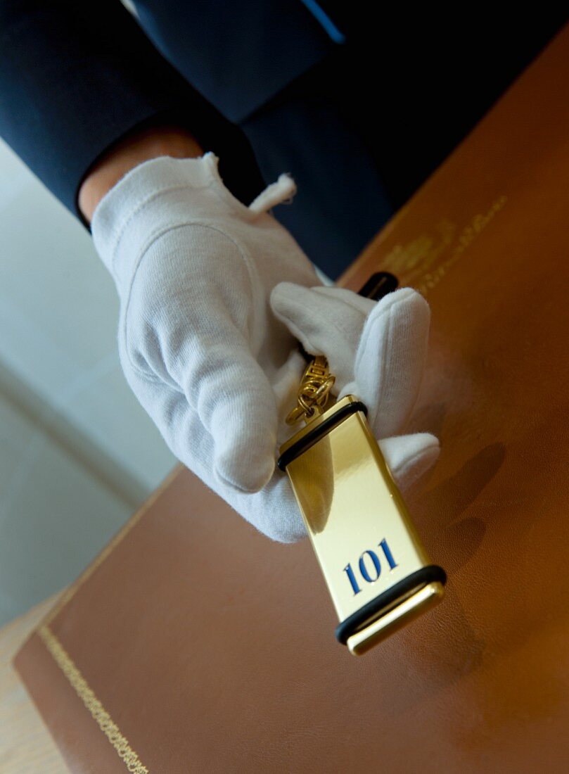 Hotel valet holding room key