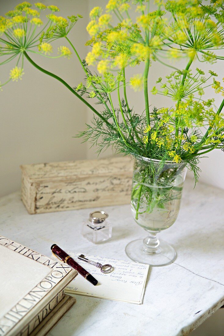 Flowering stalks in glass vase on table