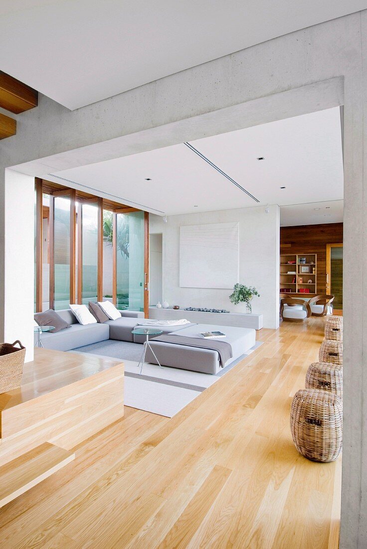 Modern sofa in corner of bright, open-plan living area in contemporary, architect-designed house