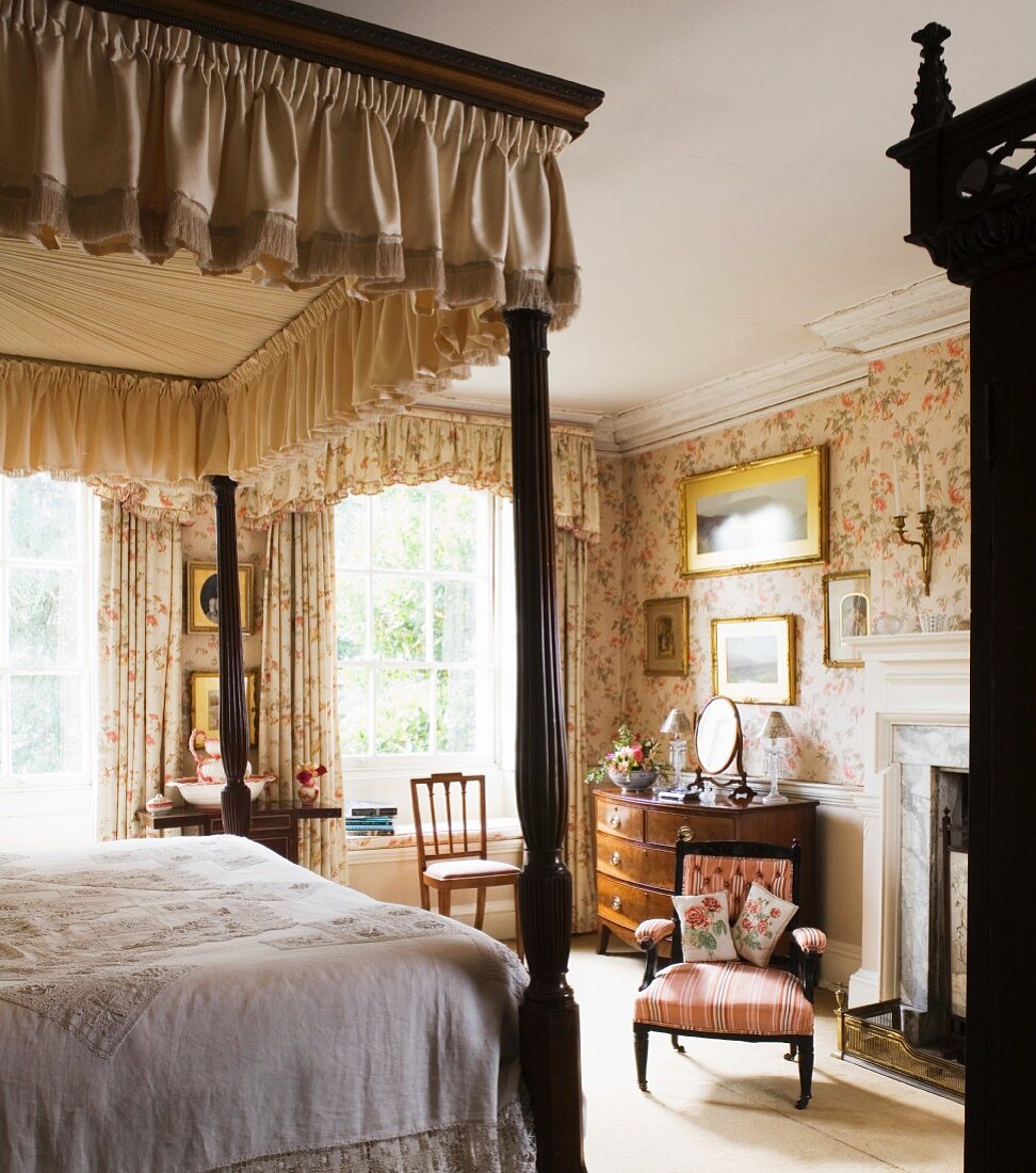 Bedroom with antique English furniture and floral wallpaper