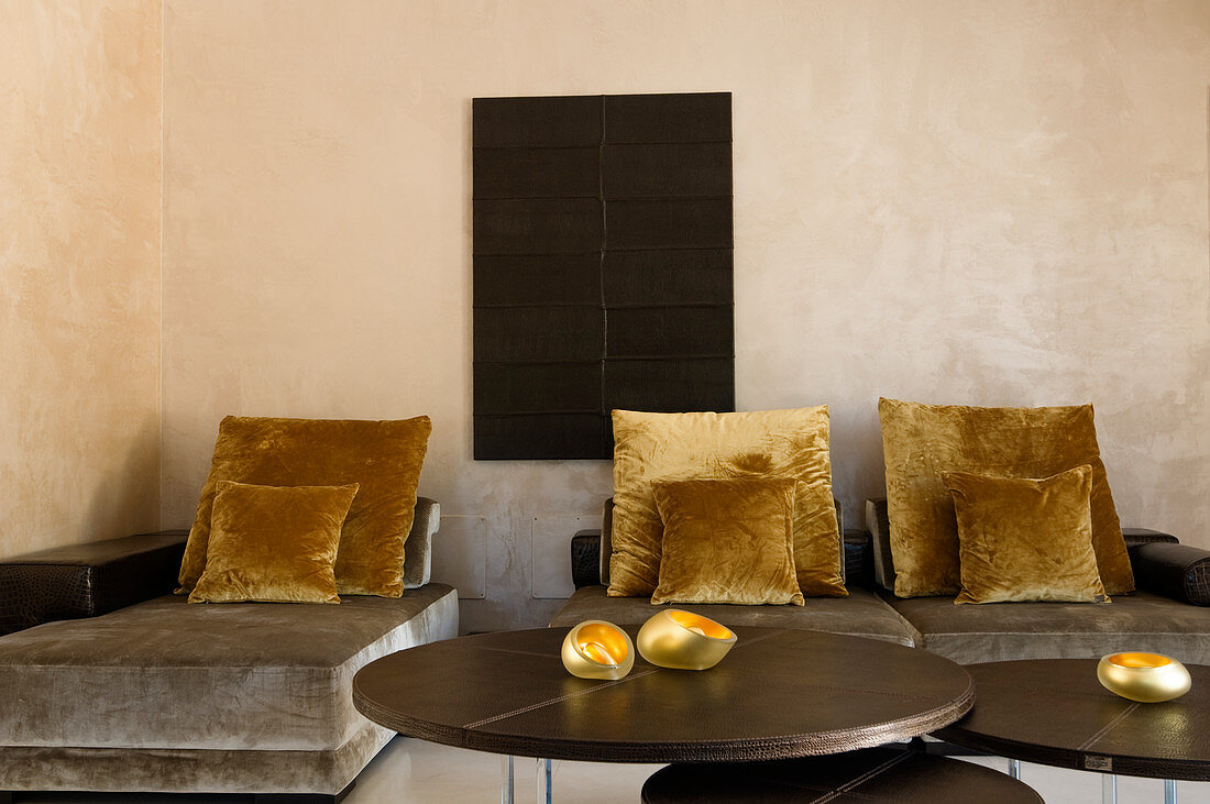 Sitz- und Liegepolster mit grauem Samtstoffbezug und Kissen in Gold in minimalistischem Raum