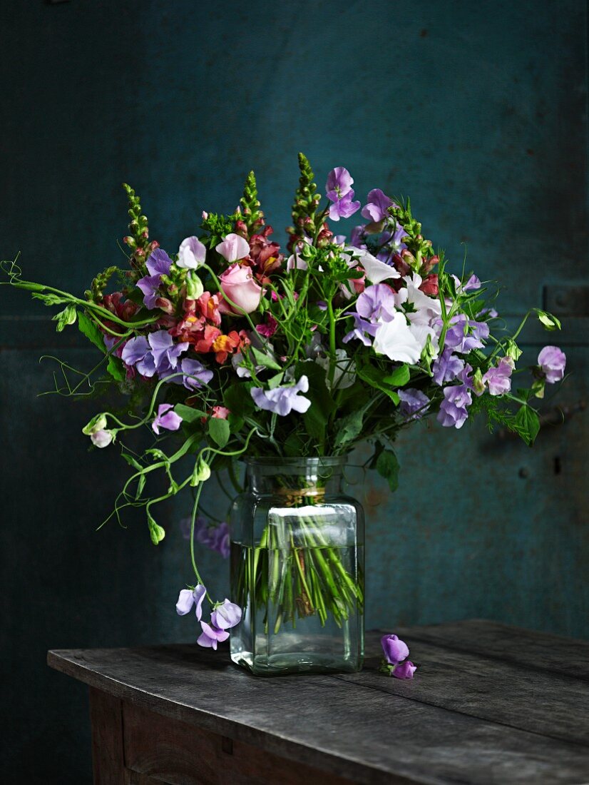 Bouquet of sweet peas on wooden table