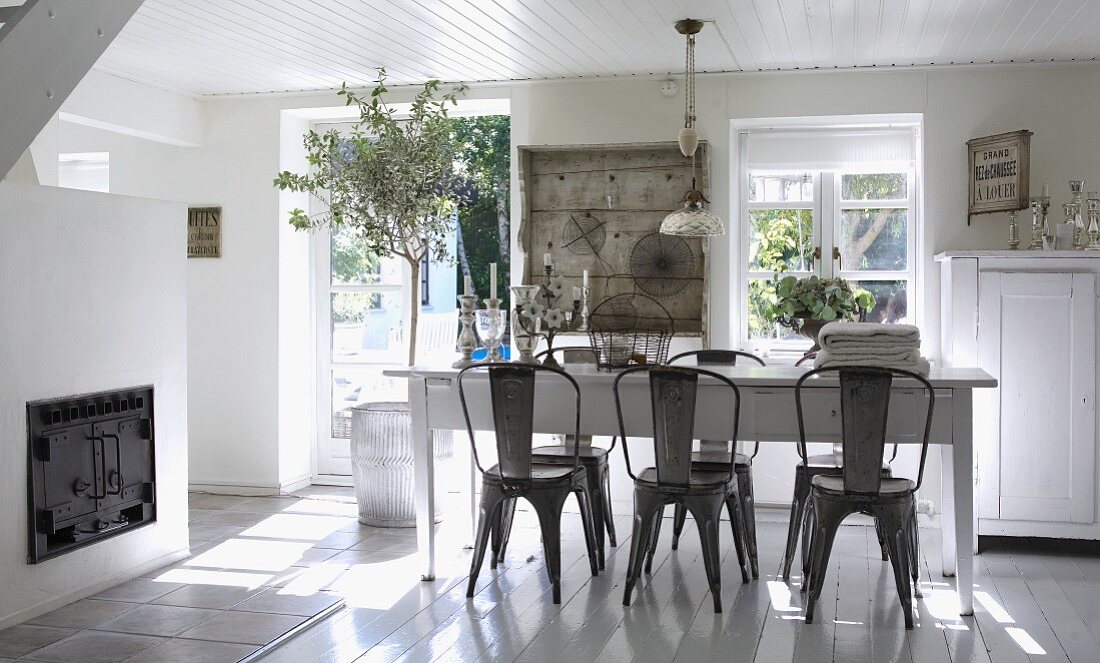 Country style dining room with dark wood chairs at white table