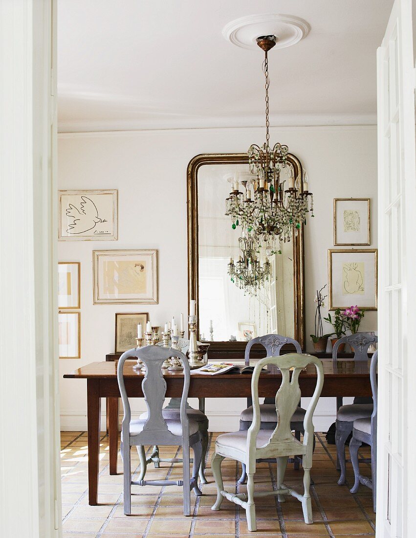 View into dining room with Rococo-style chairs through open door