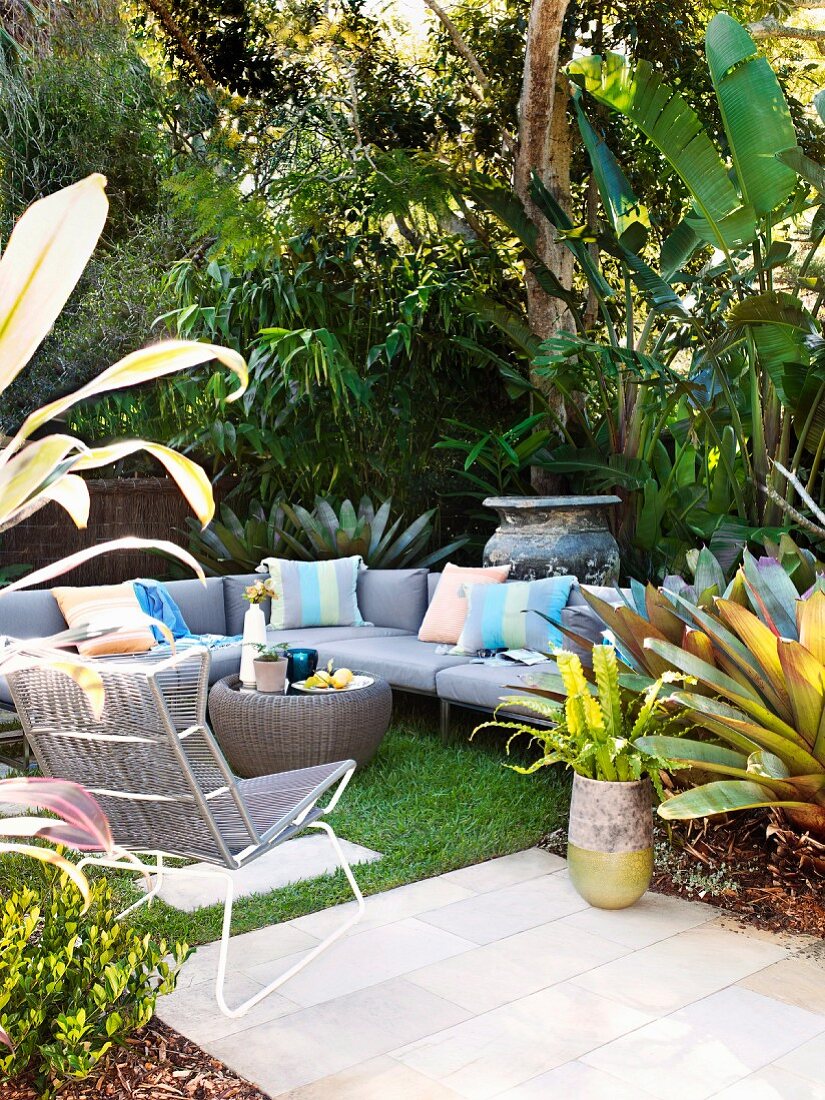 Grey sofa set with striped cushions on terrace