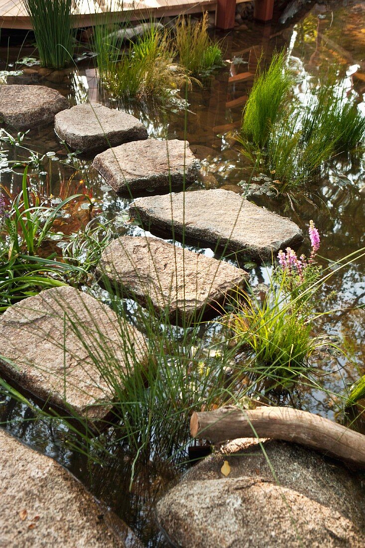 Granite stepping stones leading to terrace through water