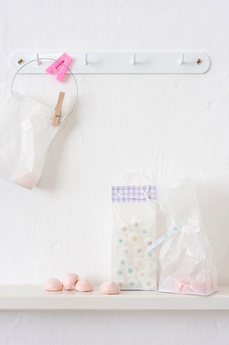 Sweets in plastic bags on hook and shelf