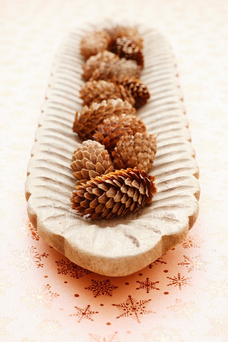 Pine cones in a wooden bowl
