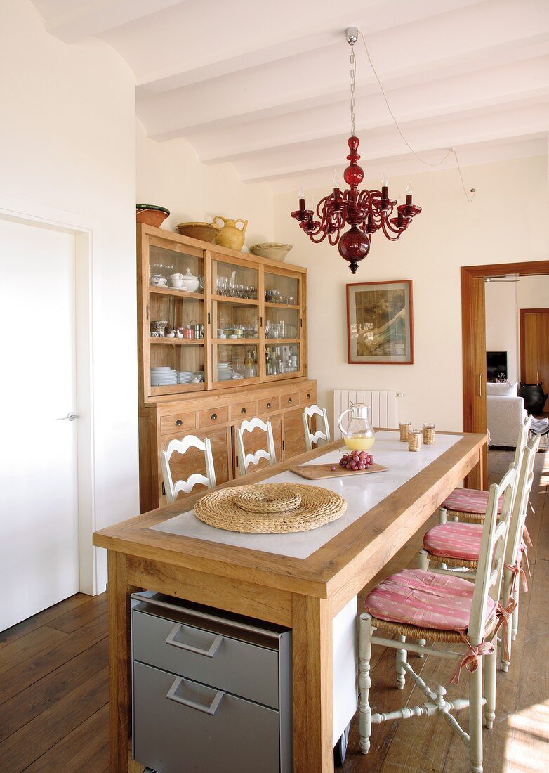 Mediterranean dining room with turned wooden chairs and wooden table with modern inlaid panel