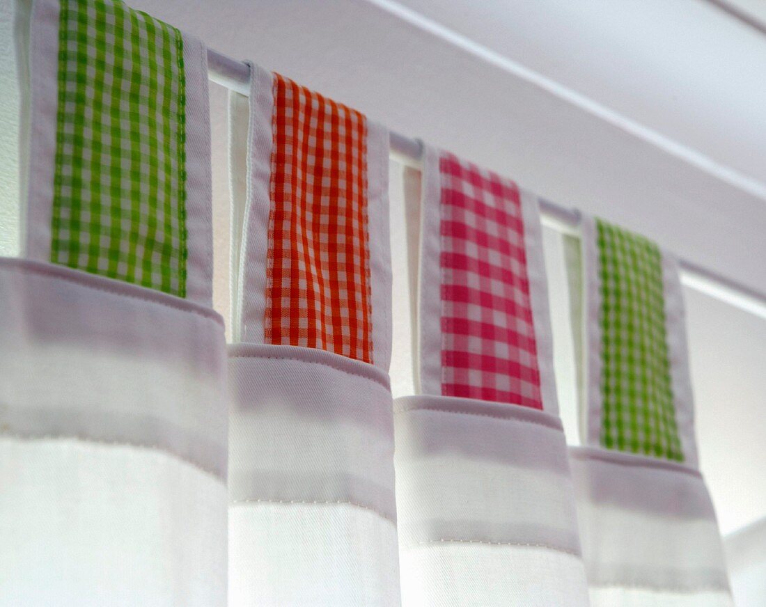 Curtain with loops of checked fabric on curtain rod