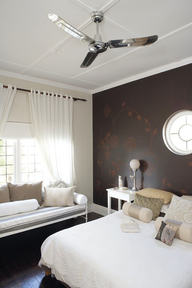 Dark bedroom walls and floor provide the perfect backdrop for white bed linen