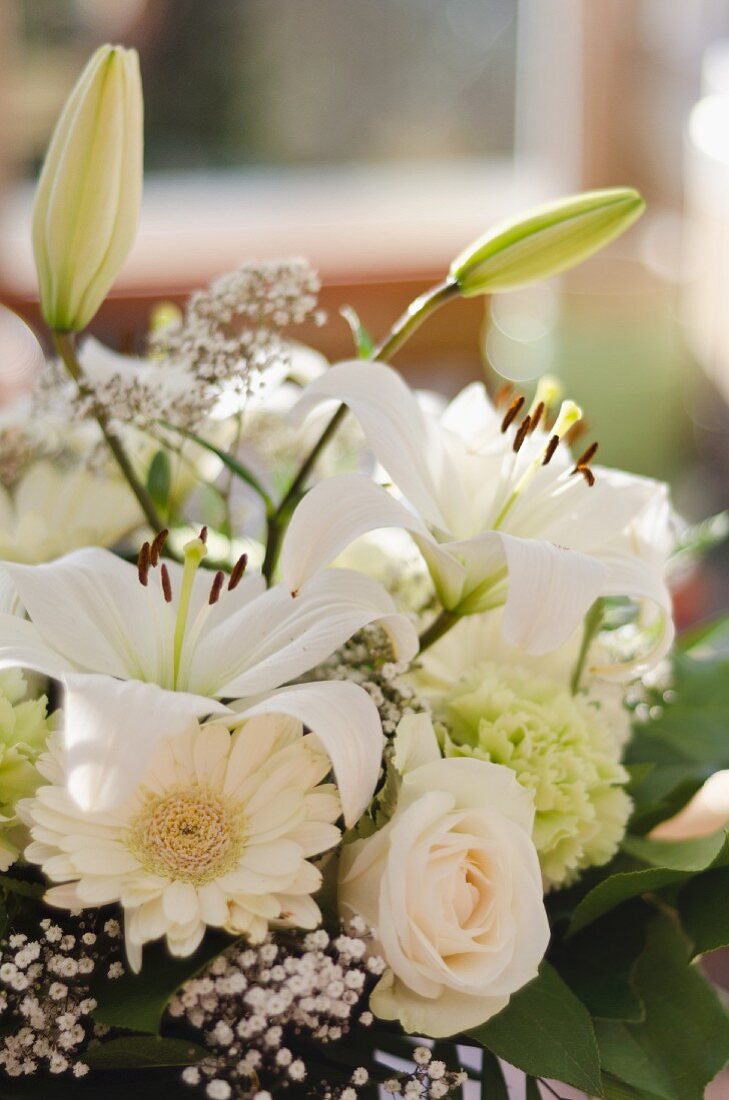 White bouquet of gerbera daisies, roses, carnations and lilies