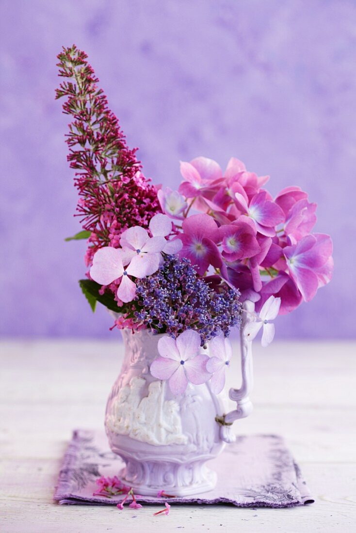 Pink hydrangeas and summer lilacs in a porcelain vase
