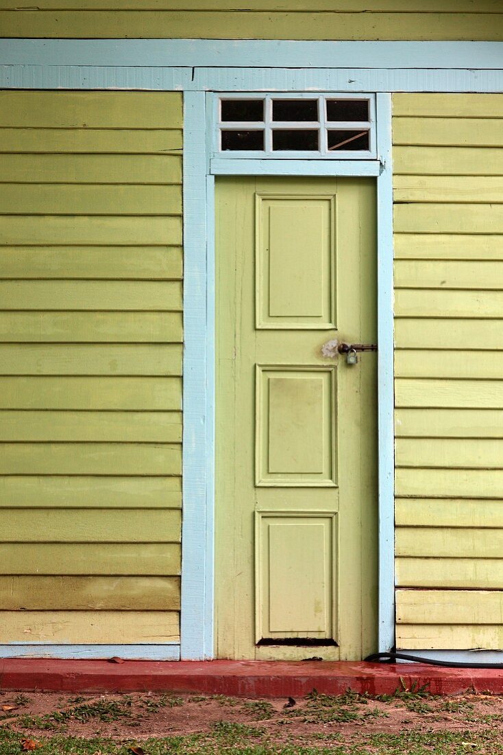Front door of yellow-painted wooden house