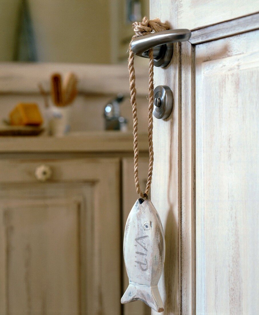 Fish pendant hanging on bathroom door handle