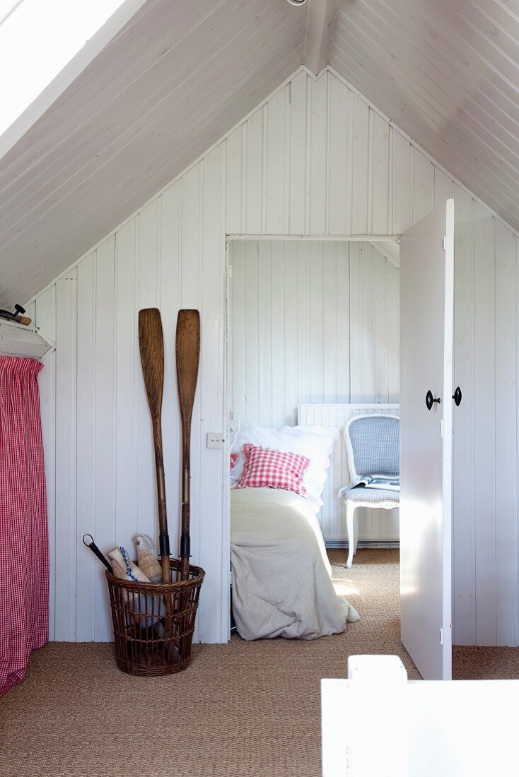 View into white bedroom with gable ceiling