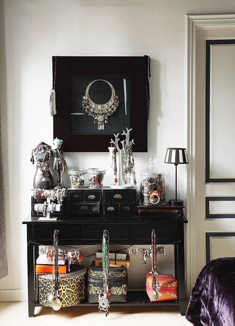 Jewellery and storage boxes on black console table