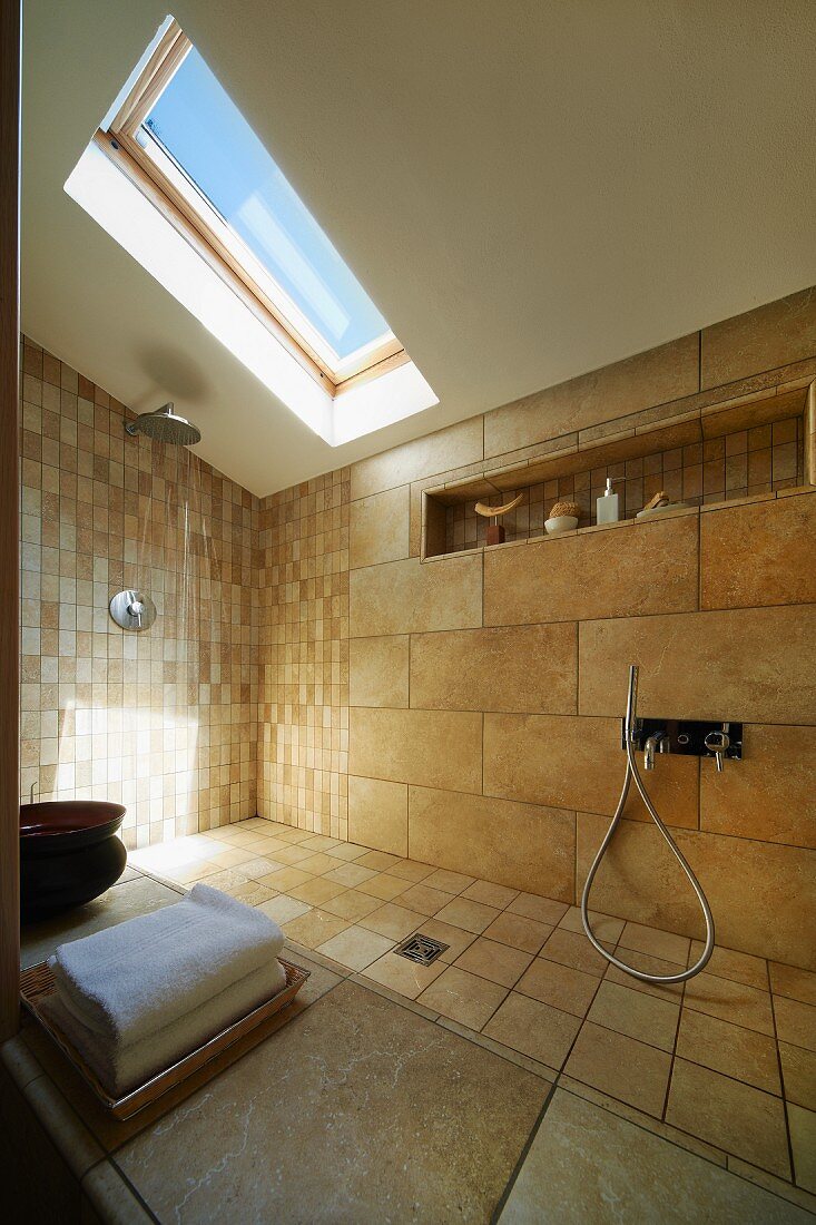 Designer bathroom in attic - tiled shower area with wall and floor tiles of different sizes
