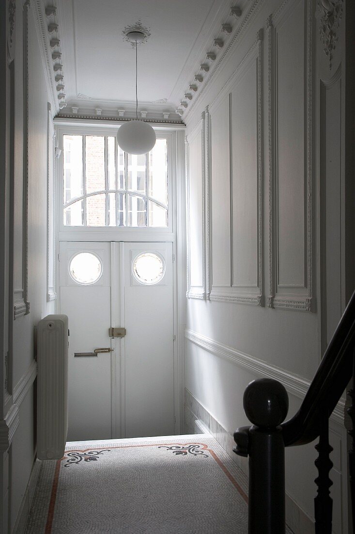 Art Nouveau entrance hall with modern, spherical pendant lamp