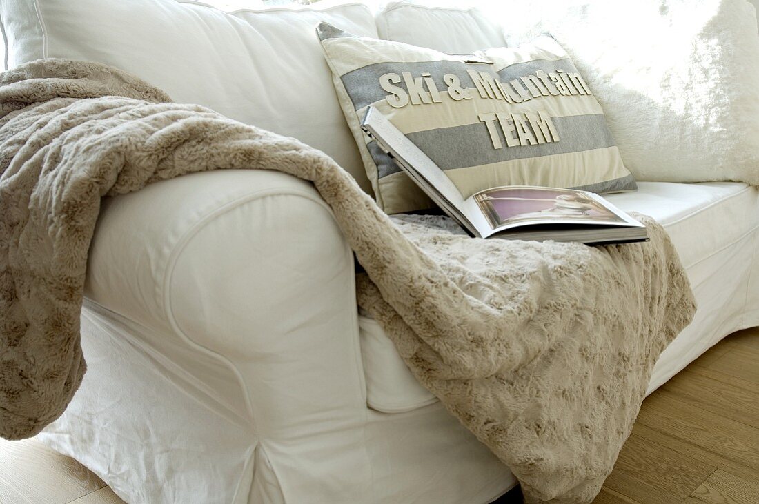 Woolen blanket and cushion on couch