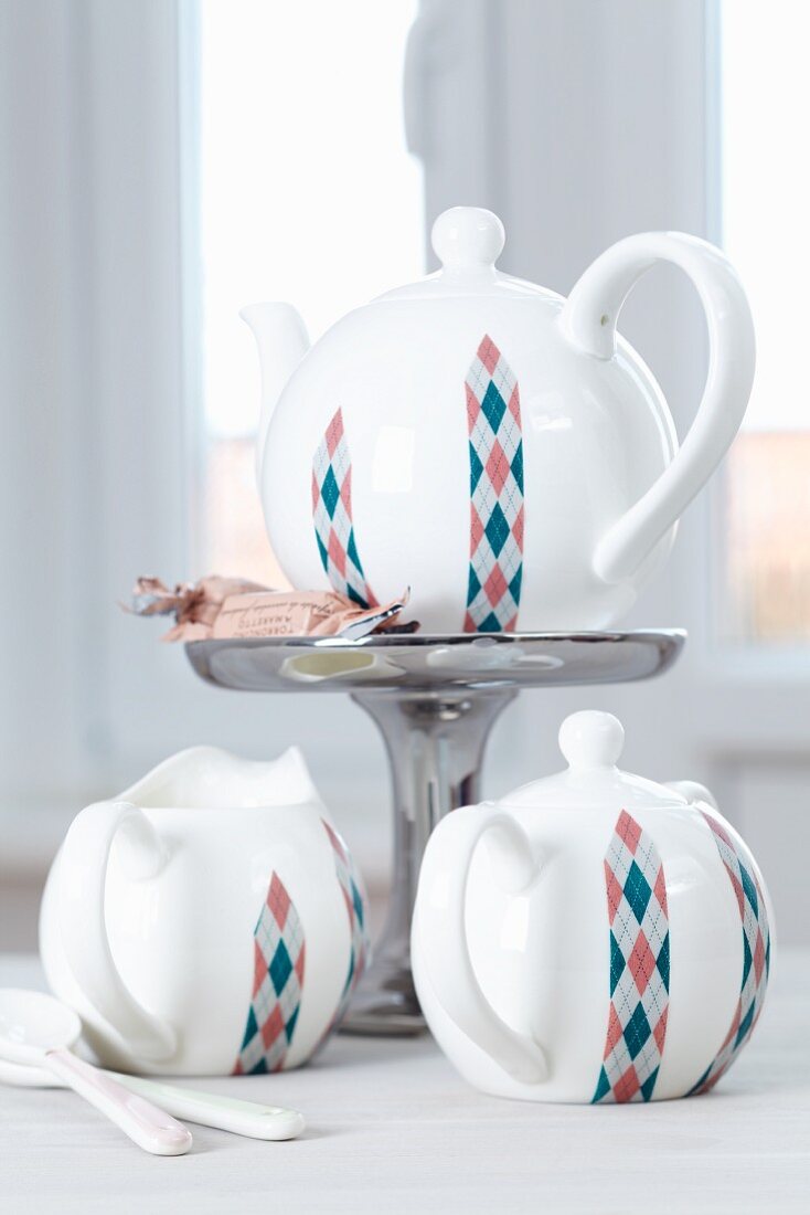 White tea service decorated with strips of Argyle-patterned tape