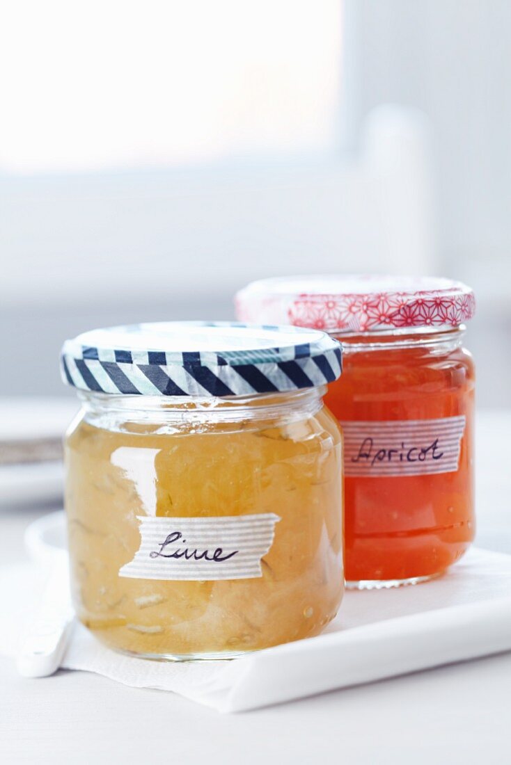 Jam jars with colourful masking tape on the lids and masking tape for labels