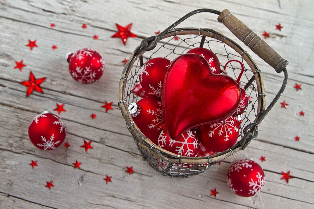 Red Christmas decorations in wire basket
