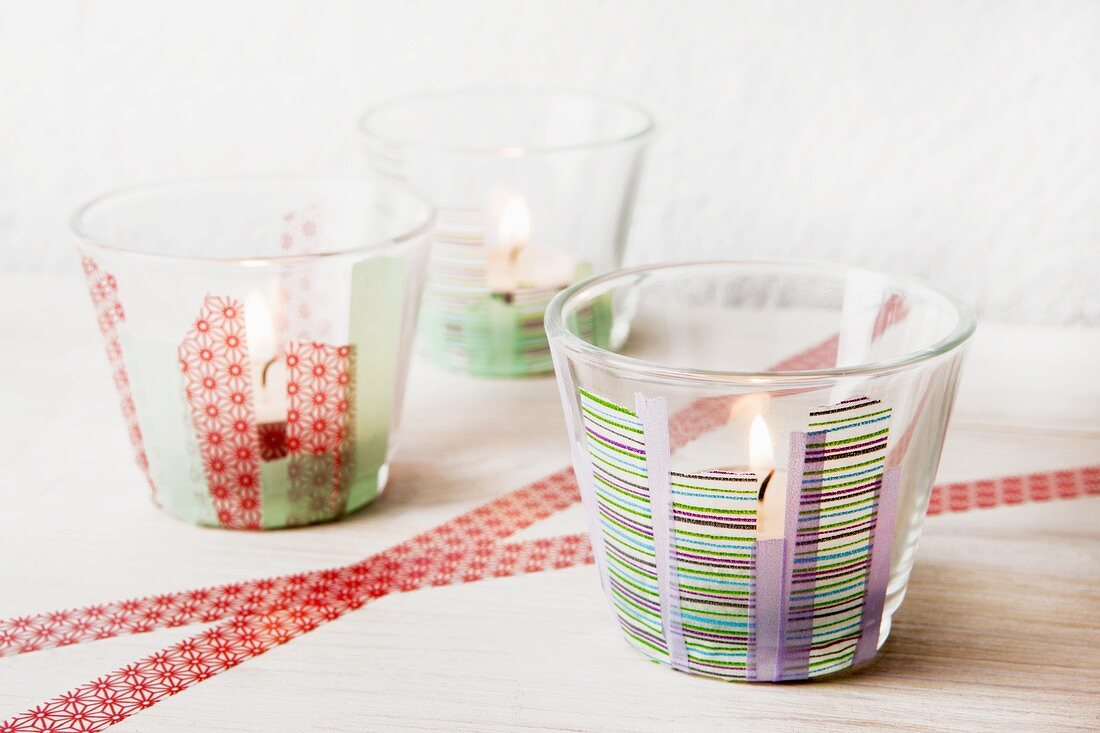 Three tealights in small glasses decorated with masking tape
