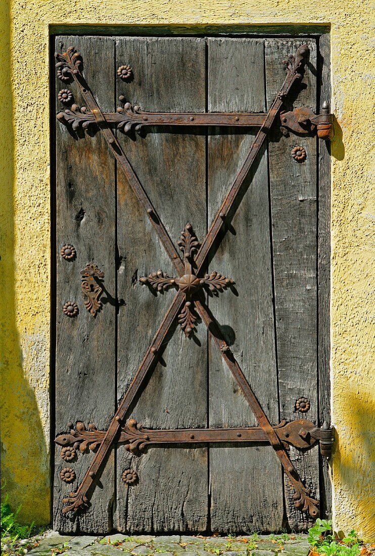 Antique wooden door with wrought iron fittings