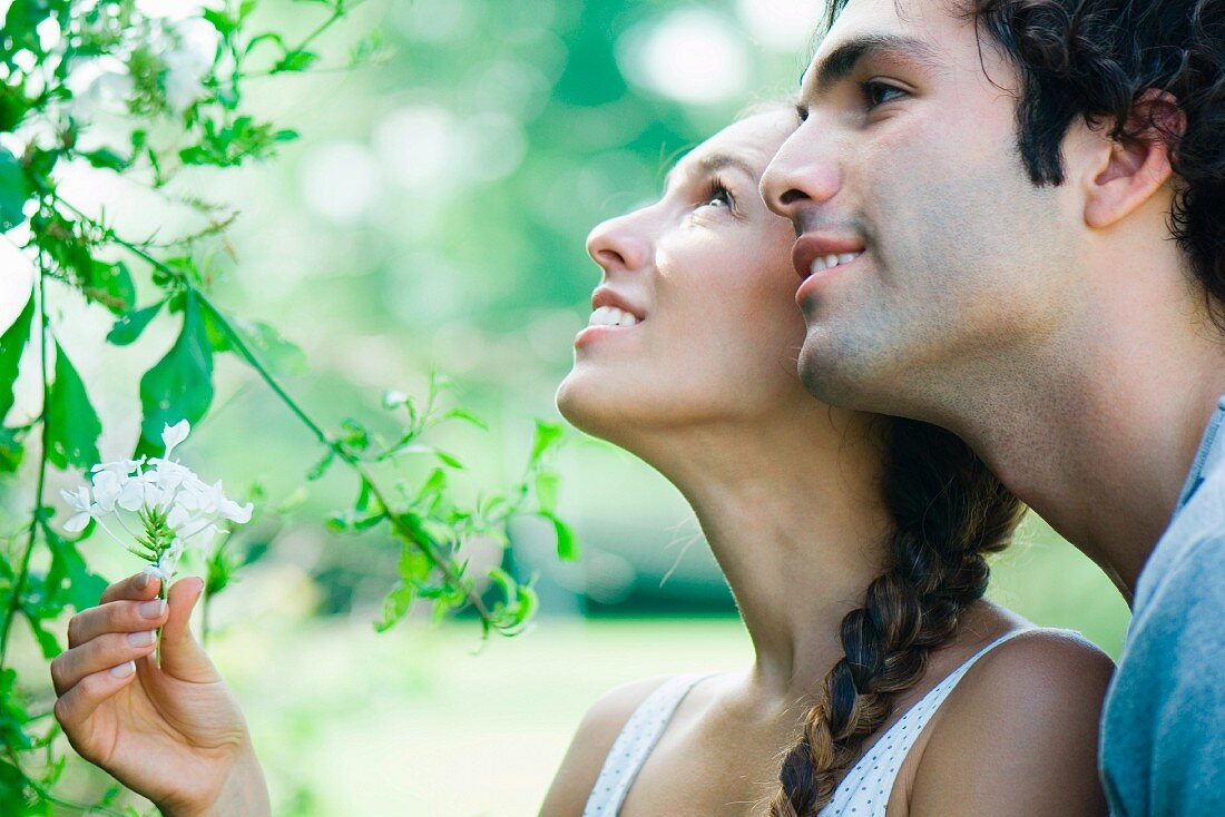 Couple looking at flowering plant together
