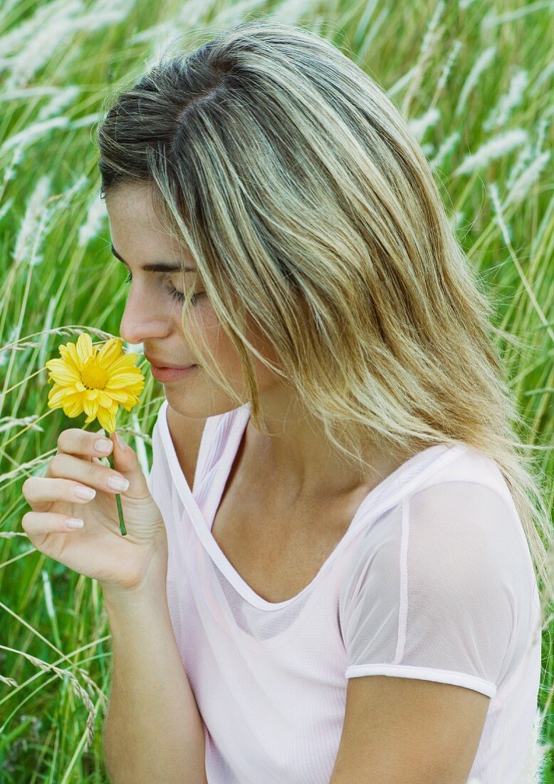 Woman smelling flower