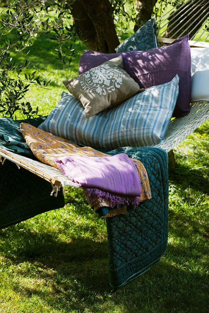 Shady spot in garden with hammock and cushions