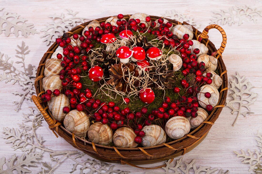 Basket of snail shells, berries and fly agaric ornaments
